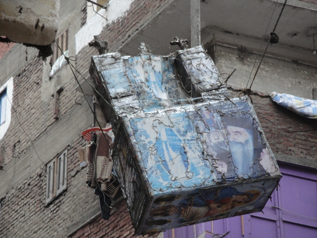 An altar hanging above a street in Manshiet Nasser