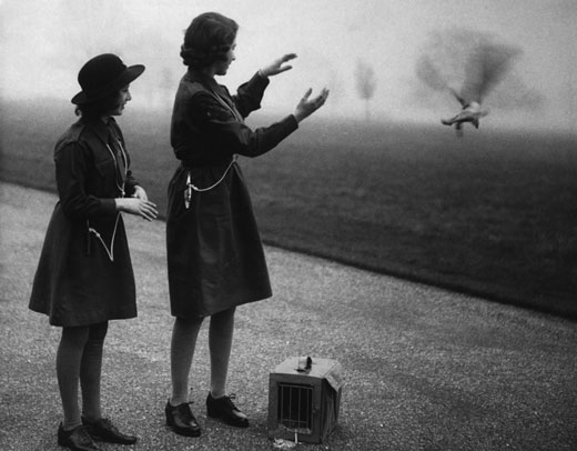 Princesses Elizabeth and Margaret wearing brogues to release a carrier pigeon
