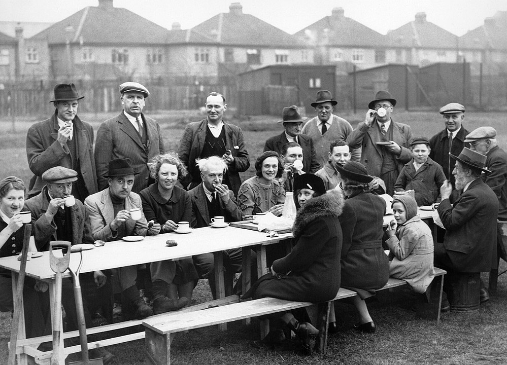 ‘Amateur gardeners down tools for tea and sandwiches on an allotment in Acton in 1940’, in a Ministry of Information photograph.