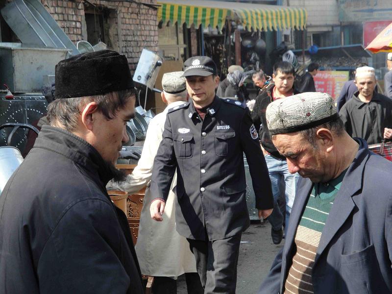 A Uighur policeman on a backstreet in Urumqi
