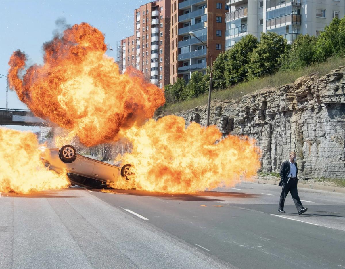 Kenneth Branagh walks away from (or is it towards?) an exploding car. 